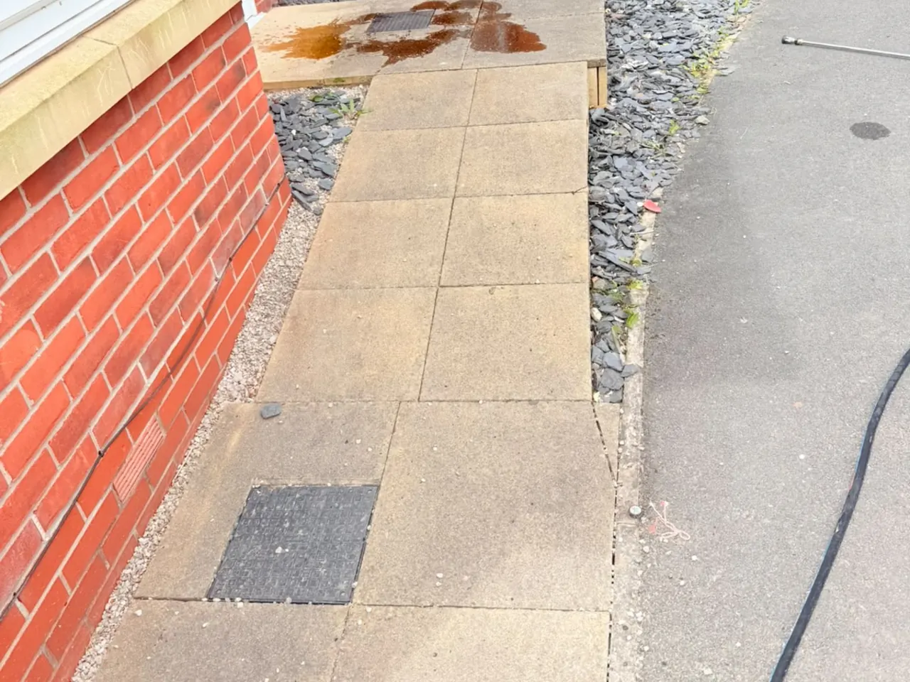 A concrete slab path with rust staining across the slabs.